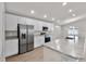Well-lit kitchen with white cabinetry, stainless steel appliances, granite countertops, and an island at 1106 Tropea Ln, Auburndale, FL 33823