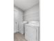 Clean laundry room with washer, dryer, and wire shelving for easy organization at 1106 Tropea Ln, Auburndale, FL 33823
