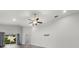 Open-concept living room featuring neutral walls, ceiling fan and sliding doors to outside at 1106 Tropea Ln, Auburndale, FL 33823
