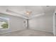 Bright main bedroom features a tray ceiling, neutral walls, and large windows at 1106 Tropea Ln, Auburndale, FL 33823