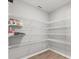 Walk-in pantry with wire shelving to maximize storage and a stylish wood-look floor at 1106 Tropea Ln, Auburndale, FL 33823