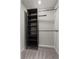 Walk-in closet features wood shelving at 1106 Tropea Ln, Auburndale, FL 33823
