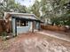 Charming single-story home featuring a pergola, wood fence, and drought-tolerant landscaping at 1160 Austin St, Bartow, FL 33830