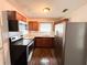 Well-lit kitchen featuring stainless steel appliances, wooden cabinets, and marble-look counters at 1160 Austin St, Bartow, FL 33830