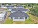 The home has a simple, modern roof and green grass in the backyard at 1171 Windjammer Dr, Lakeland, FL 33803
