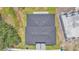 An aerial view of the home's roof and surrounding green grass and landscaping at 1171 Windjammer Dr, Lakeland, FL 33803