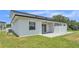 Home exterior featuring a manicured lawn and patio, perfect for relaxation and outdoor activities at 1171 Windjammer Dr, Lakeland, FL 33803