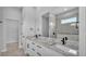 Bathroom featuring double vanity, quartz countertops, and sleek fixtures at 1171 Windjammer Dr, Lakeland, FL 33803
