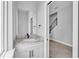 Elegant half-bathroom with marble countertop, modern black faucet, and staircase view at 1171 Windjammer Dr, Lakeland, FL 33803
