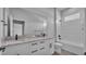 Stylish bathroom featuring dual sinks, a large mirror, and a shower-tub combo at 1171 Windjammer Dr, Lakeland, FL 33803