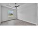 Bright bedroom with tray ceiling, ceiling fan, and large window at 1171 Windjammer Dr, Lakeland, FL 33803