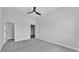 Spacious bedroom featuring carpet floors, ceiling fan, and a door to a walk-in closet at 1171 Windjammer Dr, Lakeland, FL 33803