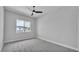 Bright bedroom featuring carpet floors, ceiling fan, and a backyard view at 1171 Windjammer Dr, Lakeland, FL 33803