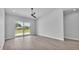 Open bedroom with tile floors, ceiling fan, and a sliding glass door with backyard views at 1171 Windjammer Dr, Lakeland, FL 33803
