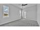 Bright bedroom featuring plush carpeting, a ceiling fan, and natural light streaming through large windows at 1171 Windjammer Dr, Lakeland, FL 33803