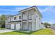 Modern two-story home featuring a light gray exterior, white accents, and a well-maintained lawn at 1171 Windjammer Dr, Lakeland, FL 33803