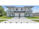 A modern duplex with dual two-car garages, well-manicured lawns, and a shared driveway at 1171 Windjammer Dr, Lakeland, FL 33803