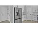 Modern kitchen featuring stainless steel refrigerator and white cabinetry at 1171 Windjammer Dr, Lakeland, FL 33803