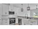 Bright kitchen with stainless appliances, farmhouse sink, and pendant lighting at 1171 Windjammer Dr, Lakeland, FL 33803