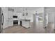 Modern kitchen with white cabinetry, stainless steel appliances, and an open layout to the living area at 1171 Windjammer Dr, Lakeland, FL 33803