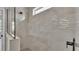 Modern shower featuring unique tile design and glass enclosure at 1171 Windjammer Dr, Lakeland, FL 33803
