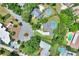 Aerial view of property with a swimming pool and green surroundings in a residential area at 1218 Lake Point Ter, Lakeland, FL 33813