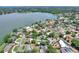 An aerial view highlighting the home's proximity to the lake, surrounded by lush trees and well-maintained homes at 1218 Lake Point Ter, Lakeland, FL 33813