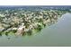 An aerial view showcasing a property's location near a lake, surrounded by green landscapes and charming homes at 1218 Lake Point Ter, Lakeland, FL 33813