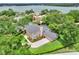 Aerial view of a home with a private pool, lush landscaping, and a spacious backyard near a lake at 1218 Lake Point Ter, Lakeland, FL 33813