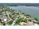 Aerial view of a property with a pool in a lush neighborhood near a lake, offering a scenic living experience at 1218 Lake Point Ter, Lakeland, FL 33813