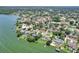 An aerial view of a property in a neighborhood with lake access, green spaces, and beautiful homes at 1218 Lake Point Ter, Lakeland, FL 33813