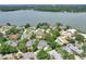 Aerial view showcasing a lakeside home with a pool and lush greenery at 1218 Lake Point Ter, Lakeland, FL 33813