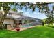A lovely backyard scene with pool, patio and landscaped lawn at 1218 Lake Point Ter, Lakeland, FL 33813