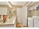 Bathroom with laundry area, vanity, and storage with easy access at 1218 Lake Point Ter, Lakeland, FL 33813