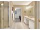 Clean bathroom featuring a walk-in shower and dual vanities at 1218 Lake Point Ter, Lakeland, FL 33813