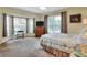 Comfortable bedroom with large bay window, ceiling fan, and television, offering a relaxing retreat at 1218 Lake Point Ter, Lakeland, FL 33813