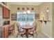 Bright dining area with a wooden table, large window, and views to the backyard at 1218 Lake Point Ter, Lakeland, FL 33813