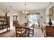 Formal dining room with a wood table, chandelier, and a view into the entry at 1218 Lake Point Ter, Lakeland, FL 33813