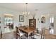 Traditional dining room featuring a wooden table, chandelier, and view into the kitchen at 1218 Lake Point Ter, Lakeland, FL 33813