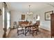 Formal dining room with a wooden table, chairs, chandelier, and classic decor at 1218 Lake Point Ter, Lakeland, FL 33813