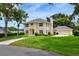 Charming two-story home with a well-maintained lawn, beautiful landscaping, and a spacious garage at 1218 Lake Point Ter, Lakeland, FL 33813