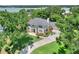 Aerial view of a beautiful two-story home with a well-manicured lawn and lush landscaping near a lake at 1218 Lake Point Ter, Lakeland, FL 33813