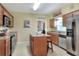 Bright kitchen featuring stainless steel appliances, granite countertops, and a central island at 1218 Lake Point Ter, Lakeland, FL 33813