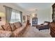 Comfortable living room with a sofa, chaise lounge, and view into the entryway at 1218 Lake Point Ter, Lakeland, FL 33813