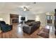 Spacious living room with hardwood floors, brick fireplace, and comfortable leather sofas at 1218 Lake Point Ter, Lakeland, FL 33813