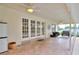 A brick paved covered patio with seating options overlooking the pool area at 1218 Lake Point Ter, Lakeland, FL 33813