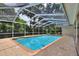A blue screened-in pool with brick deck at 1218 Lake Point Ter, Lakeland, FL 33813