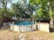 Backyard area features an above ground pool, perfect for summer fun and relaxation at 135 E Columbia St, Lake Alfred, FL 33850