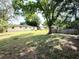 Backyard with large lawn area, in-ground pool and rear home elevation at 135 E Columbia St, Lake Alfred, FL 33850