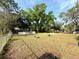 The backyard featuring lush greenery and an above ground pool at 135 E Columbia St, Lake Alfred, FL 33850